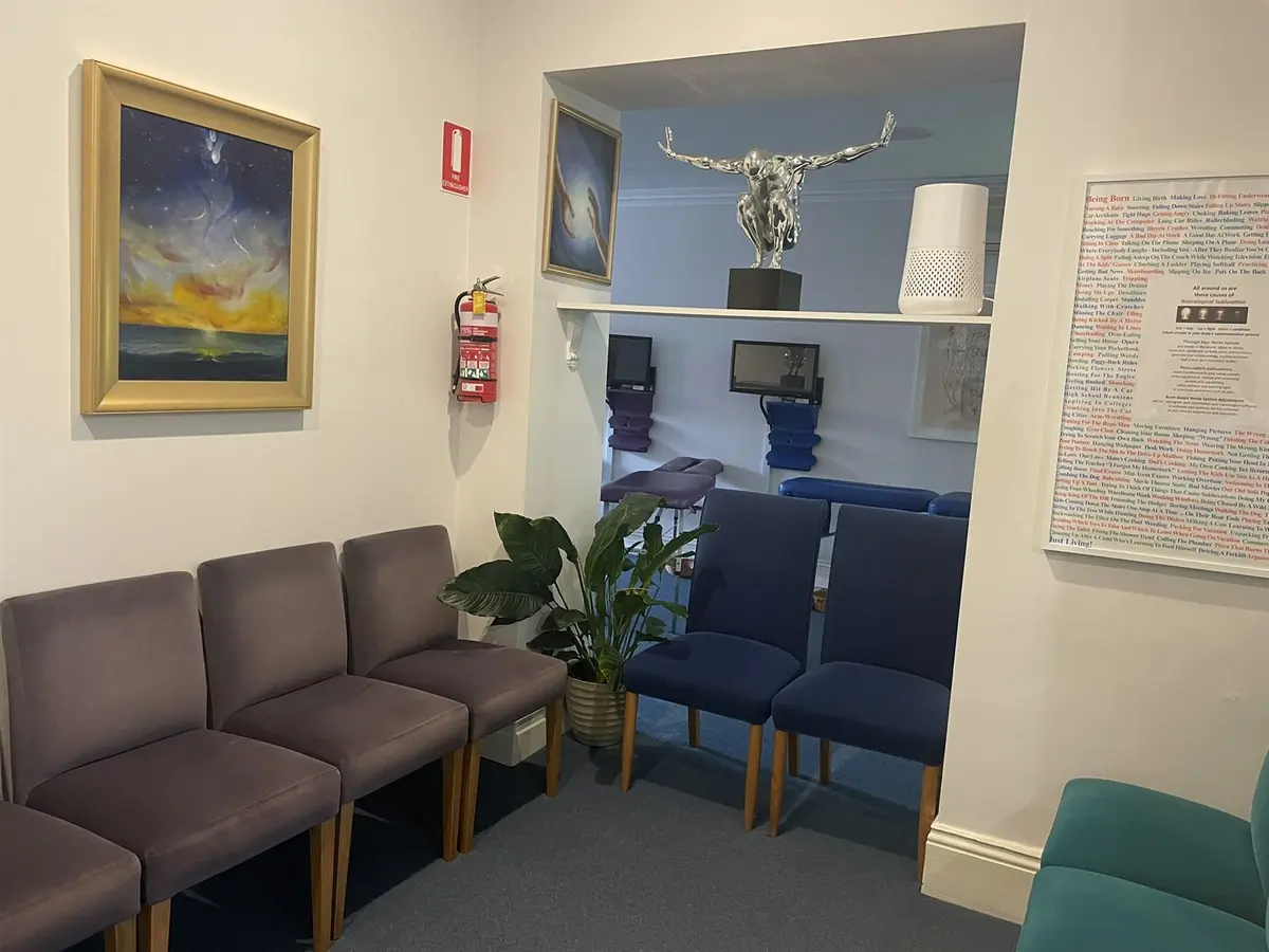 The client lounge at the Fitzroy Centre with framed paintings, a sculpture and plants