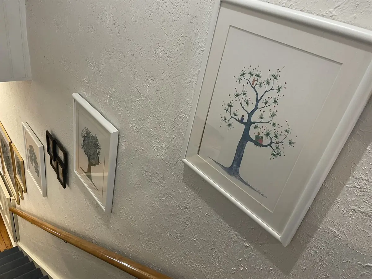 Framed tree prints hung along the staircase wall of the Fitzroy rooms