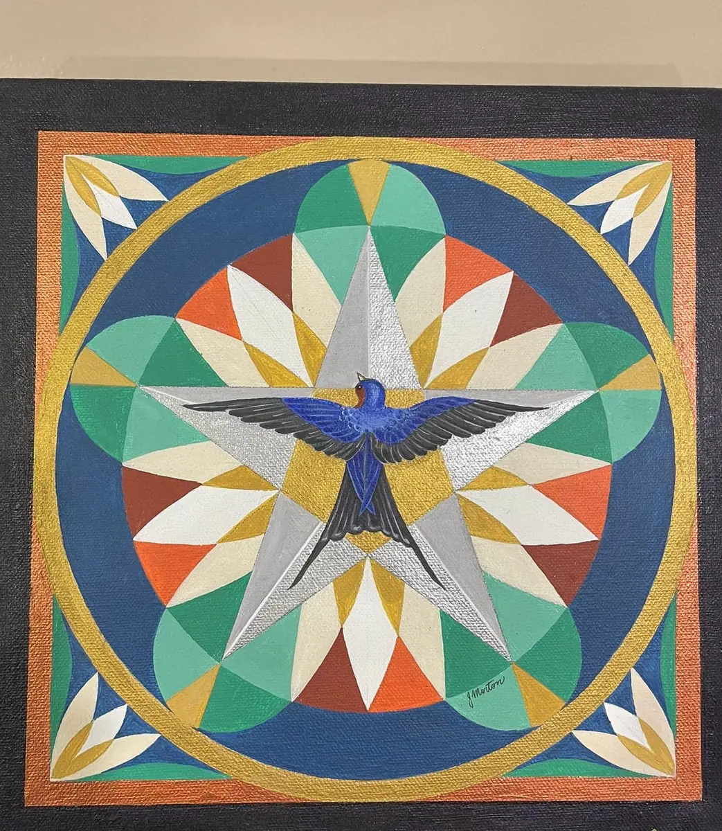 Geometric mandala painting: a blue swallow over a silver star, ringed by gold and jewel-toned petals