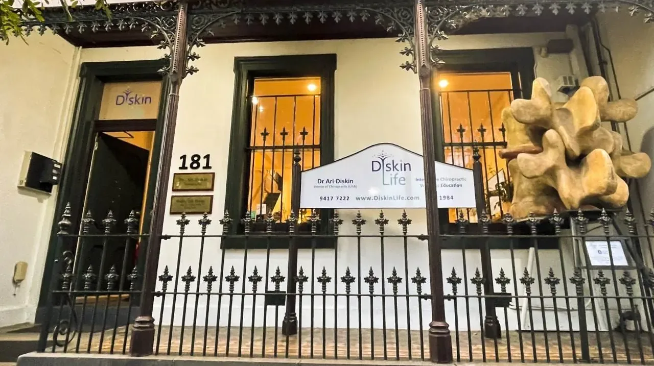 The front of the Diskin Life Centre at 181 Victoria Parade: the number, the Diskin Life sign, the giant vertebra and the Victorian ironwork